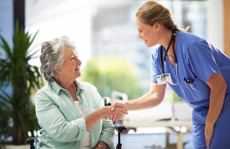 Family members compare assisted living notes beside a laptop, care checklist, and facility brochures.